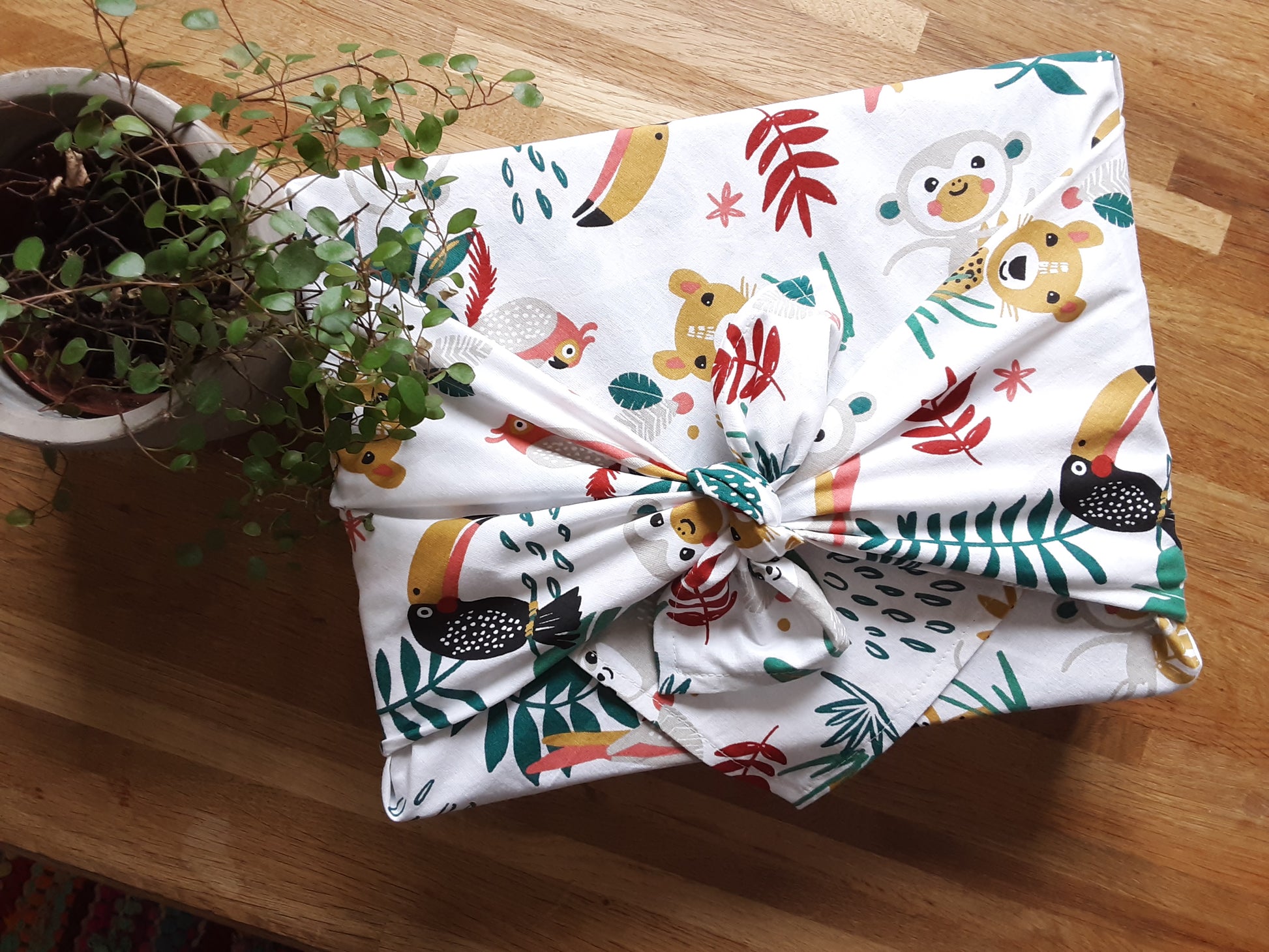 Furoshiki avec un tissu en coton de couleur blanc avec des motifs animaux de la jungle. Emballage cadeau écologique et réutilisable. accessoire zéro déchet.